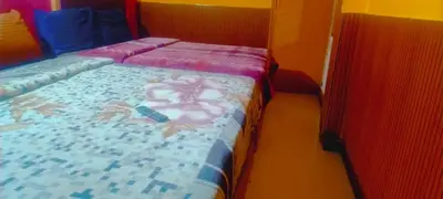 a bedroom with a bed with a blanket with crabs on it at Suriya Residency in Ooty