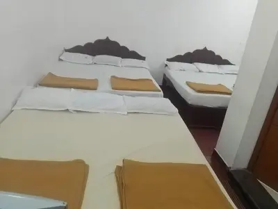 two twin beds in a room withthritisthritisthritisthritisthritisthritisthritisthritisthritis at Kurinji home stay munnar in Munnar