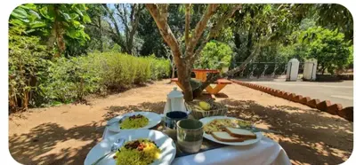 a table with plates of food on top of it at Nakoor volkot in Suntikoppa