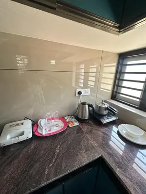 a kitchen counter with a blender and a plate on it at AP'S Homestay Nilambur in Nilambūr