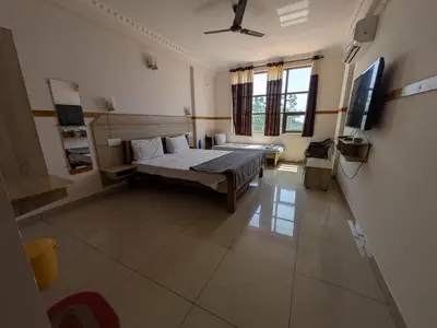 a bedroom with a bed and a flat screen tv at Pegasus Home in Coimbatore