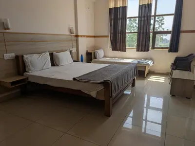 a bedroom with two beds and a window at Pegasus Home in Coimbatore