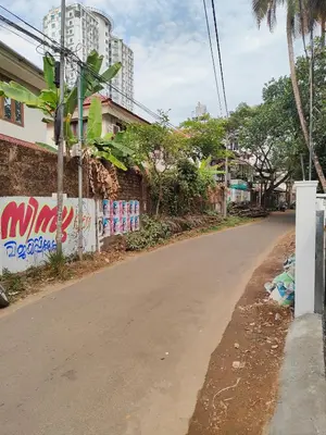 an empty street in a city with tall buildings at Ivory Suites County in Kozhikode
