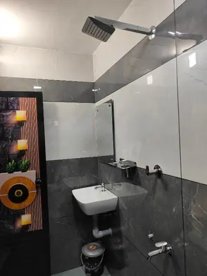 a bathroom with a sink and a mirror at Ivory Suites County in Kozhikode