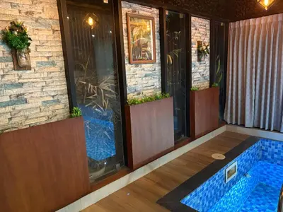 a room with a swimming pool in a house at Evania Pool Suites in Nedumbassery