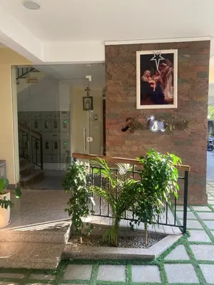 a bench in a building with plants in front of it at Evania Pool Suites in Nedumbassery