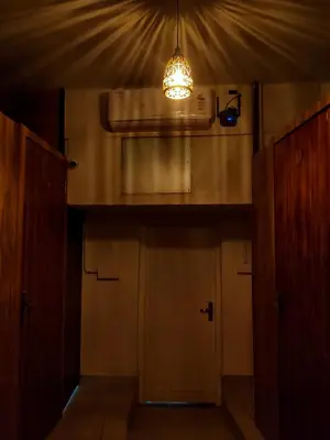an empty room with a light hanging from a ceiling at Thekkini rooms and Dorms in Kozhikode