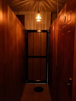 a hallway with a door and a chandelier at Thekkini rooms and Dorms in Kozhikode