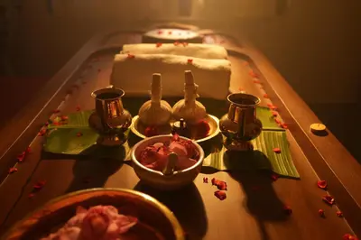 a table with a cake on a table with some food at Vaigayi Ayurveda Resort in Kodanad