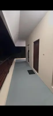 an empty room with a white floor and a window at Offline Resort in Bengaluru, Karnataka