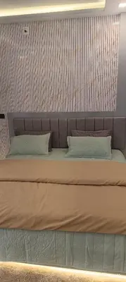 a large bed with two pillows on top of it at blue Mount stay in Gūdalūr
