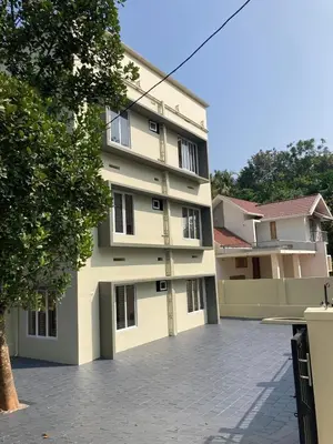 a large white building with a lot of windows at Ocean pearl homestay-Manjeri in Malappuram