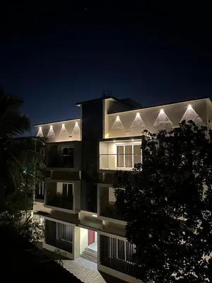 a large building at night with its lights on at Ocean pearl homestay-Manjeri in Malappuram