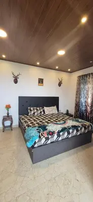 a bedroom with a large bed in a room at IndivaStays - Sixface Park in Ooty