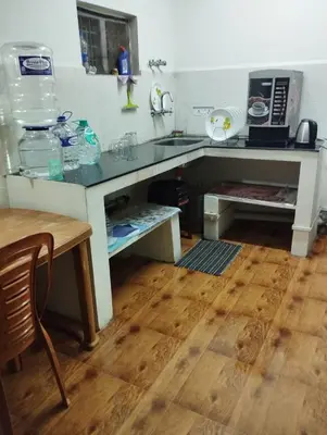a kitchen with a sink and a counter top at Arnold Home Stay Ooty in Ooty