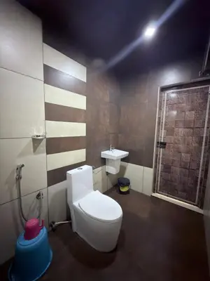 a bathroom with a toilet and a sink at Aditi By Greenleaves Resort Vythiri in Vythiri