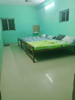 a bedroom with a large bed in a room at Om Cottage in Palani