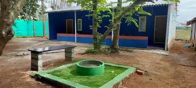 a bench and a table in front of a building at Lavi's Homestay in Hārohalli