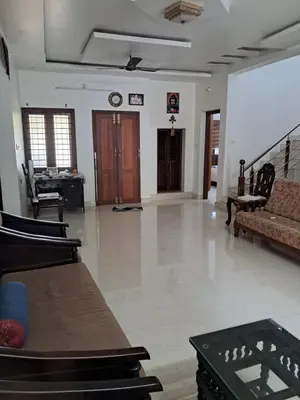 a living room with a couch and a table at Vilasini Nivas in Irinjālakuda