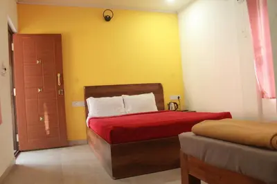 a bedroom with a red bed and a yellow wall at Aranya Cottage Coorg in Suntikoppa
