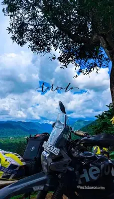 a motorcycle parked under a tree on a hill at The EDGE Paradise in Neriyamangalam