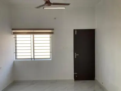 a room with a black door and a window at V-host in Alwaye