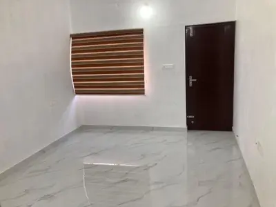 a empty room with a door and a white wall at V-host in Alwaye
