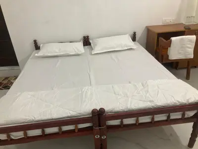 a bed with two pillows on it in a room at V-host in Alwaye