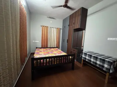 a small bedroom with a bed and a window at Puranattukara- Serene Stay by the Rice Fields in Trichūr