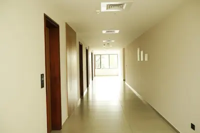 an empty corridor of a building with a hallway at Dwaraka INN