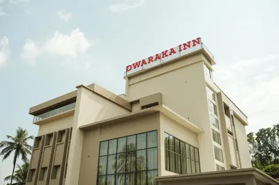 a building with a sign on top of it at Dwaraka INN