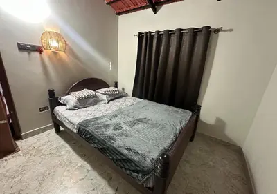 a bedroom with a bed with a black bed frame at Sol Malai Retreat near MM Hills by Travent Mug