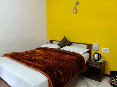 a bedroom with two beds and a yellow wall at White House Resort in Ooty