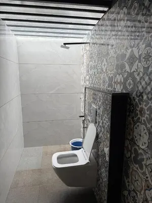 a bathroom with a toilet in a wall at Dhani Nature Stay in PÄndavapura