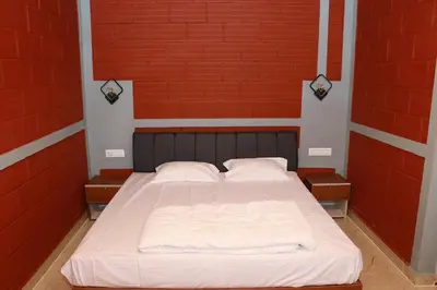 a bed in a room with red brick walls at Dhani Nature Stay in PÄndavapura