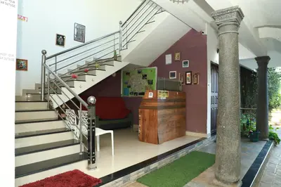 a staircase in a house with a lobby at Clement homes in Kalpetta