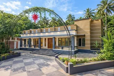 a house with an arch in front of it at Luxury Garden Villa, Free Breakfast in Guruvayoor in Manattala
