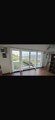 a room with a large window with a view at Artists getaway in Kodaikānāl