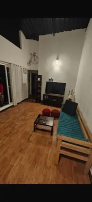 a living room with a couch and a table at Artists getaway in Kodaikānāl