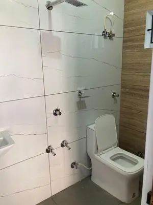 a bathroom with a toilet and a sink at vhost in Alwaye