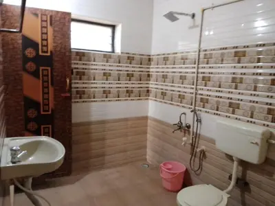 a bathroom with a sink and a toilet and a shower at SHI's Triveni Spacious 2BHK Villa in Pappampatti in Chettipālaiyam