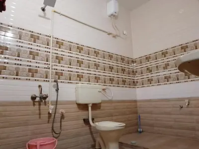 a bathroom with a toilet and a shower at SHI's Triveni Spacious 2BHK Villa in Pappampatti in Chettipālaiyam
