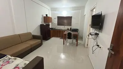 a small living room with a couch and a table at 1bhk Kalp 200m temple Thulasi nagar in Guruvāyūr