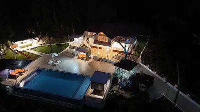 an overhead view of a swimming pool at night at Kadmane Resort in Kākankote