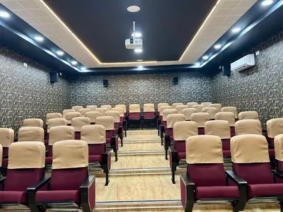 an empty lecture hall with chairs in it at BR Farm Stay in Coimbatore