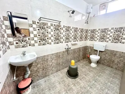a bathroom with a sink and a toilet at BR Farm Stay in Coimbatore