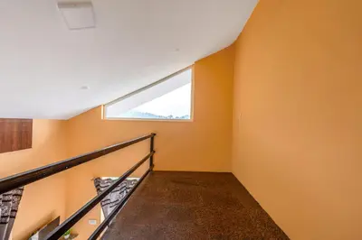 a staircase in a house with a window at Orchid Villa Kotagiri in Kodanād