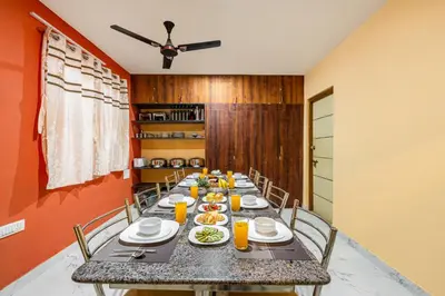 a dining room with a long table with food on it at Orchid Villa Kotagiri in Kodanād