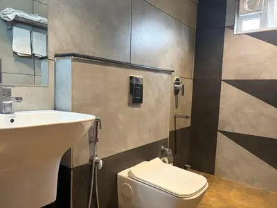 a bathroom with a toilet and a sink at Raravies family restaurent Mattanur,Near Kannur airport in Chāvasseri