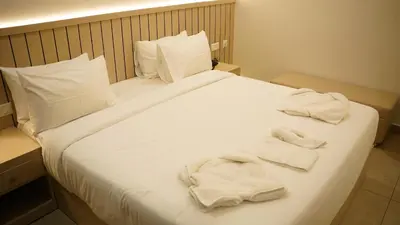 a bed with white towels on top of it at VOX holiday in Palakkad